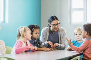 teacher with kids at table - archived virtual events